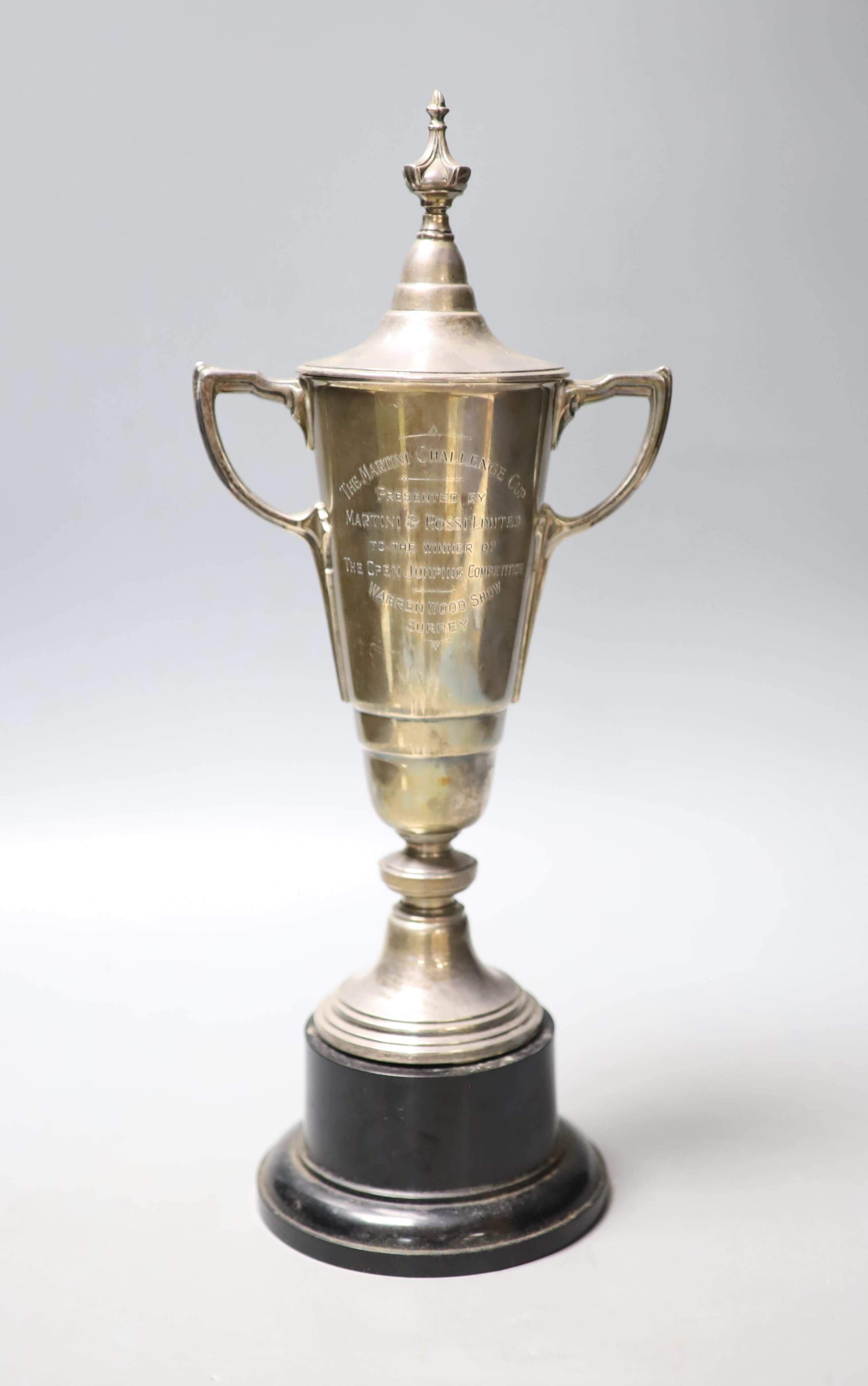 A 1950's silver two handled presentation trophy cup and cover, Adie Brothers, Birmingham, 1956, height 29.3cm, 12.5oz, on wooden socle.